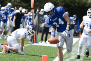 Henry Donohue crosses the end zone on March 27 against Dobbs Ferry. Donohue had three touchdowns in Bronxville’s one-sided win.