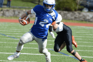 Henry Donohue sheds a Tuckahoe tackler on April 1. Donohue rushed for two scores and threw for another in Bronxville’s 38-0 victory over the Tigers.