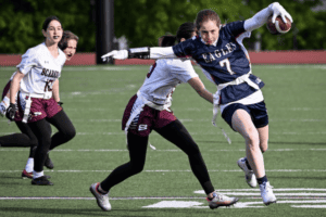 Carlie Brien avoids a tackle against Scarsdale B on May 1. Brien led the Eagles with two touchdowns on the afternoon.